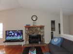 Living Room which includes a 55-inch Flat screen TV with Wood Burning Fireplace